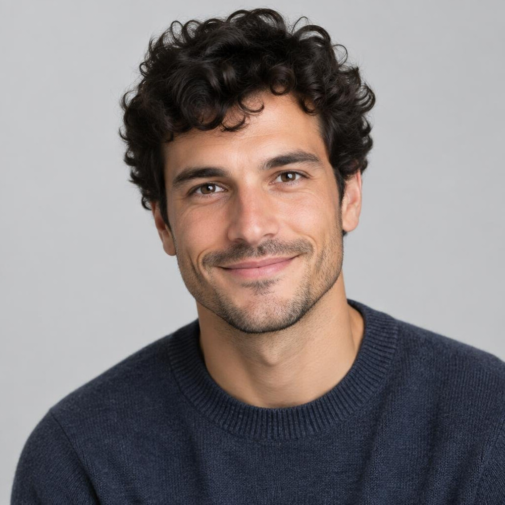 Studio portrait of a man with dark curly hair